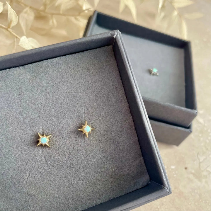 Starburst gold stud earrings with opal