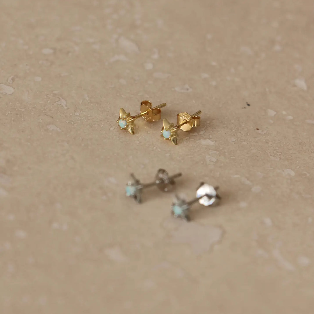 Starburst gold stud earrings with opal